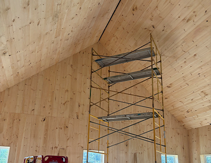Interior wood wall installation in a Marysville, OH custom barn build