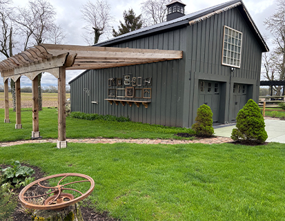 Custom barn exterior with pergola and landscaped yard in Delaware, OH